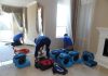 The top 5 benefits of hiring a reputable flood risk repair services: Repair crew pumping water out of a flooded building